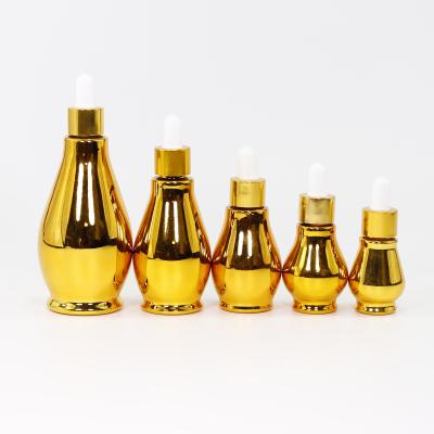 China Personal Care Gold Dropper Glass Bottles Customized Essential Oil For Cosmetic Packaging for sale