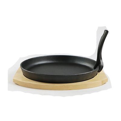 China CLASSIC Oval Pre-Seasoned Cast Iron Fajita Pan Dish Set Hot Fry Grill Sizzling Steak Pan with Wood Base for sale