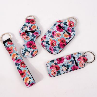 China Luxury Cheap Floral Neoprene Custom Self Defense Set Hand Sanitzer Lip Balm Stick Holder Neoprene Bracelet Bling Key Chain for sale