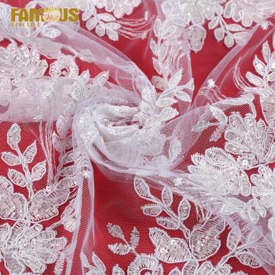 China Other fashion style 100% polyester machine beaded embroidery sequin white bridal beads lace up fabric for girls dress for sale