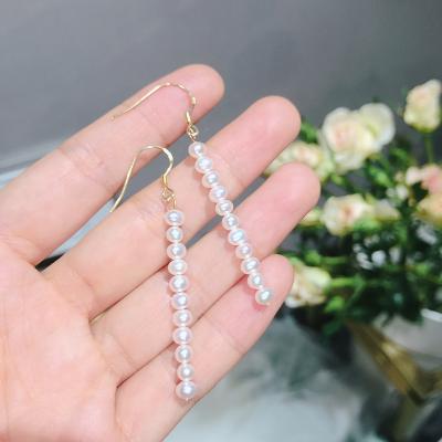 China Simple Environmental Friendly 925 Sterling Silver Gold Plated One Row Of Natural Freshwater Pearl Drop Earrings for sale