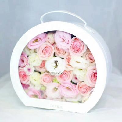 China Recyclable Wholesale Cardboard Flower Packaging Box Luxury Round Flower Gift Box With Suitcase Handle for sale