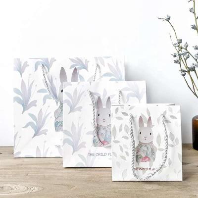 China Custom Cute Rabbit Design White Paper BIODEGRADABLE Gift Shopping Bag With PP Rope Handles for sale